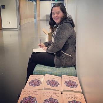 Katelyn Reed with all of the books she signed